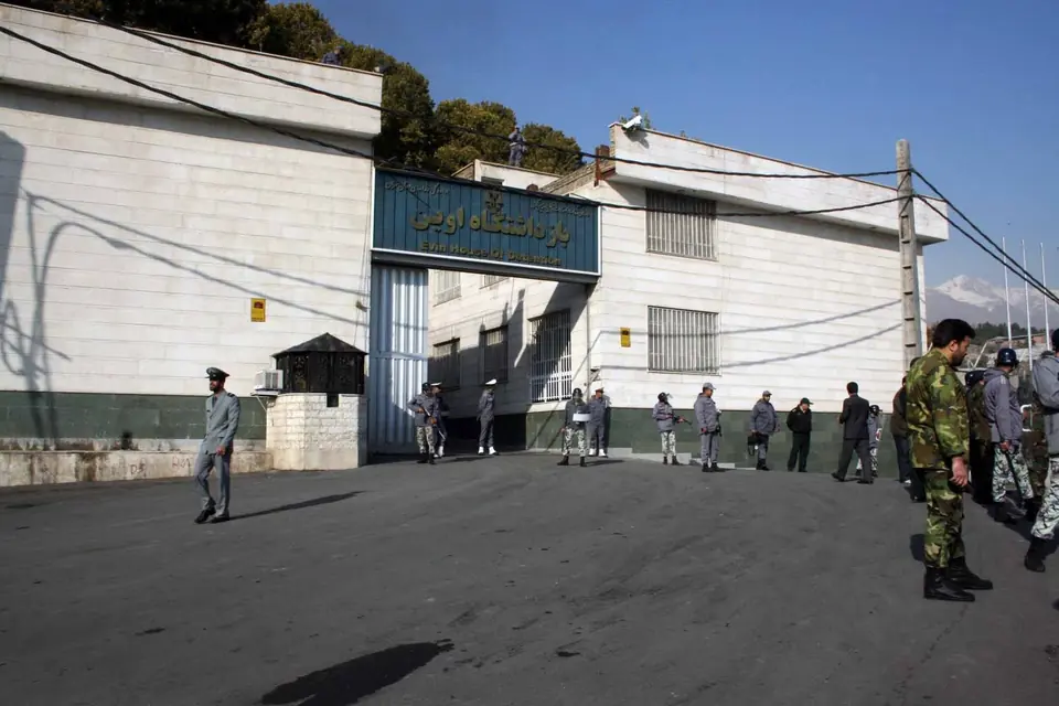 The gated entrance of Evin House of Detention in Tehran, with guards on the street outside