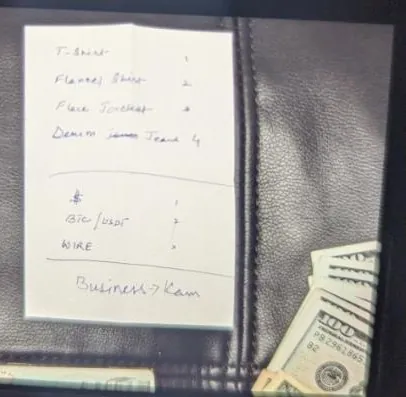 A handwritten list on a folded slip of paper inside an open wallet